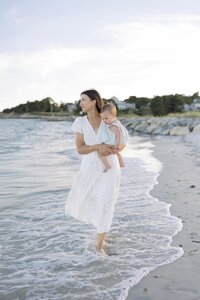 A coastal New England family session with toes in the sand and salty snuggles by the water's edge. North Shore Family Photographer. Deborah Zoe Photography.