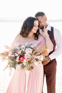 Kiamarie with her fiance holding a bouquet