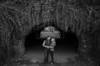 Central park engagement photos, Deborah Zoe Photography. A couple pose under a bridge in Central Park.