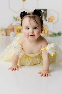 With daisies on her dress and sunshine in her smile, this little one lit up her first birthday session. Captured by Yucaipa cake smash photographer Kaitlyn Dawn Photography.