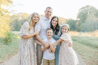 family all snuggled together in fall outdoor session