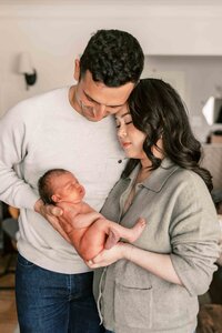 New parents gazing at their newborn baby during a Bay Area newborn photo session