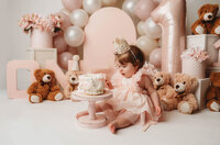 Charleston Cake Smash Photographer- Baby looks into the camera during Cake Smash Photos at Holy City Babies Portrait Studio in Charleston, SC.
