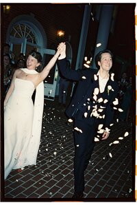 A couple holding hands during their flower petal wedding send off in Austin Texas shot on film