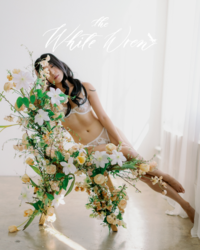 Kohnur bride in soft boudoir editorial with natural makeup, loose waves, and romantic floral styling featured on The White Wren