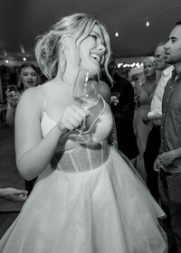 Candid photo of the bride during her wedding reception at the Abernethy Center dancing and having the best time.