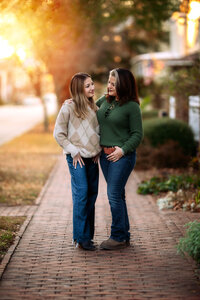 Mother and daughter smiling at each other during a fall family session in New Bern NC