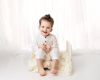 Baby boy sitting on bed, Davenport Child photographer, Child photos Davenport, Child pictures Bettendorf, Photographers in quad cities