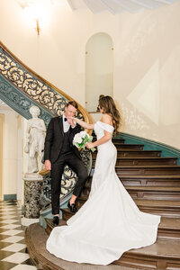 groom kiss bride hand on stairs