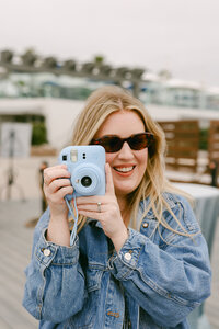 Brand event guest using an Instax camera to capture candid moments during a team offsite