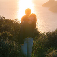 sunset couple photos on cliffside in san francisco during golden hour with dog