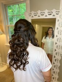 Bride viewing her finished wedding hairstyle in the mirror at The Love Loft