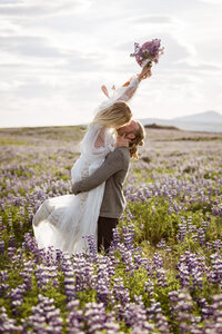 groom holding and kissing bride in iceland for elopement shoot