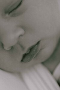 black and white close-up photo of newborn baby's lips, chin, and nose
