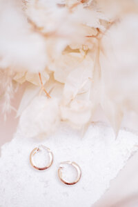 Gold vintage earrings on display with dried florals by Debbie Hemingway. Photography by Megan Moura