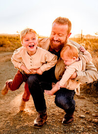 dad holding his two sons for family photography session in the Phoenix, AZ desert
