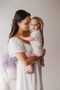 Charleston Motherhood Photographer - Mother poses with her baby during studio Mother's Day Mini Sessions at Holy City Babies Portrait Studio in Charleston, SC.