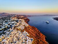 aerial view of the red cliffs with white buildings overlooking the ocean