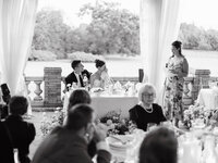 A candid black and white capture of a bride being moved by a toast at Cairnwood Estate, highlighting genuine connection.