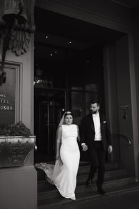 bride and groom walking out of hotel