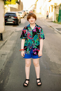 An LGBTQ teenager with short hair and Hawaiian shirt in Bénodet in France