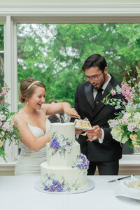 Los Angeles wedding photography fine art cake cutting photo of the bride and groom at The Secret House of Ivy, captured with cinematic lighting, true to life color, and an elegant editorial look.