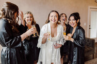 Bride laughs with bridesmaids while getting ready for wedding at The Trillium in Tennessee