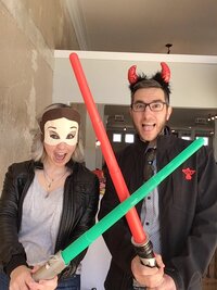 Couple with lightsabers in photobooth