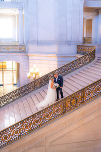 san francisco city hall bride and groom on romantic fairytale stairs