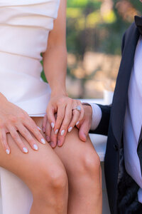 bride and groom sitting on bar at sunset at rainbow oaks ranch in sanger california.