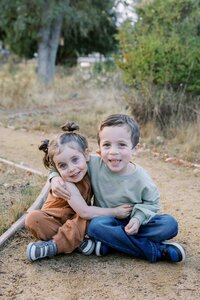 Toddler siblings hugging each other during a natural light family photo session in Palo Alto