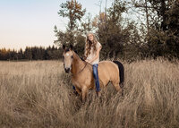 Sandy high school senior riding her horse in a field at Milo Mciver park in Estacada for her senior portrait session.