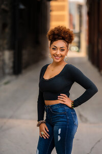 A Catholic Memorial High School senior poses in a bright alleyway for her portrait.