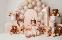 Charleston Cake Smash Photographer- Baby looks into the camera during Cake Smash Photos at Holy City Babies Portrait Studio in Charleston, SC.