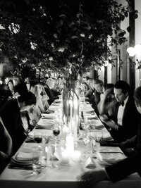 A refined composition of a long candlelit reception table at Wythe Hotel, preserving the atmosphere and emotion of an intimate dinner.