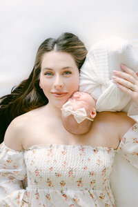 Tender moment between mother and baby fine art newborn photographer Miami