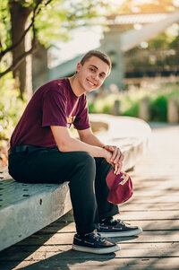 A senior student from Germantown High School sits on a bench at Boerner Botanical Gardens in Hales Corners.