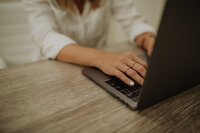 A view of a woman's hands typing on a laptop | Venue Business Boot Camp