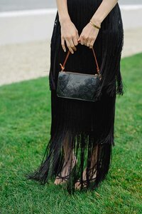 Fashionable wedding guest in black