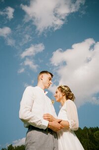 Poetic and moody film photo of a wedding couple, capturing a raw emotional moment amidst the scenic beauty of Bohemia