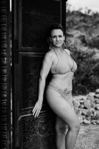 Boudoir experience outside in front of wooden doors