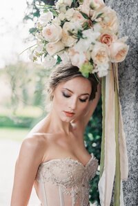 bride-holds-bouquet-flowers-her-head