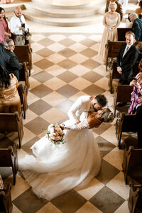 a groom dips the bride in the bella donna chapel on their exit from the ceremony captured by shelly voss