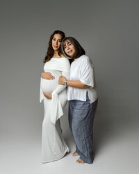 Pregnant mom standing closely with her mother, sharing a tender embrace during a maternity session by Kaitlyn Dawn Photography in Yucaipa.