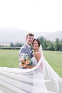 Bride and groom with bridal bouquet by Flowergirl Cville at King Family Vineyard, Charlottesville area wedding venue | Photo by Paige Ryan Photography