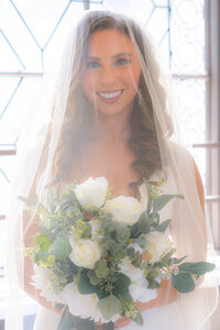 san francisco bride smiling under veil at city hall
