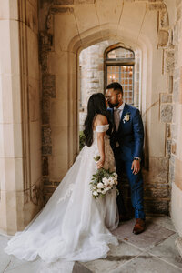 bride and groom kissing in entryway