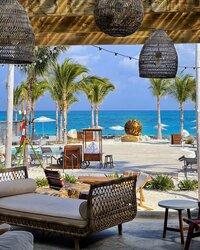 Elegant beachfront resort lounge with ocean views, ideal for relaxation and upscale vacation stays.