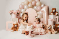 Charleston Cake Smash Photographer- Baby looks into the camera during Cake Smash Photos at Holy City Babies Portrait Studio in Charleston, SC.