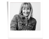Black and white headshot of Annie owner and main phtoographer of annie x photographie in a Polaroid frame